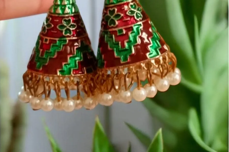 Green and red enamel earrings, styled with an everyday kurta.